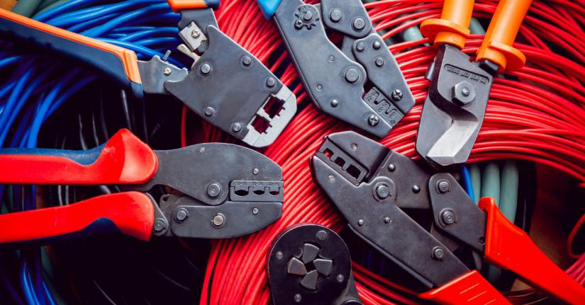 Several pairs of wire cutters laying on a pile of coiled wires before being used by an electrician in Mars, PA.