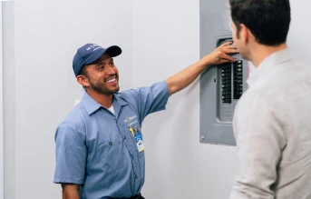 Mr. Electric electrician explaining circuit breaker replacement to a customer.