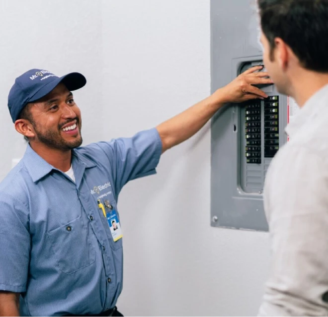 Mr. Electric electrician working on a circuit breaker.