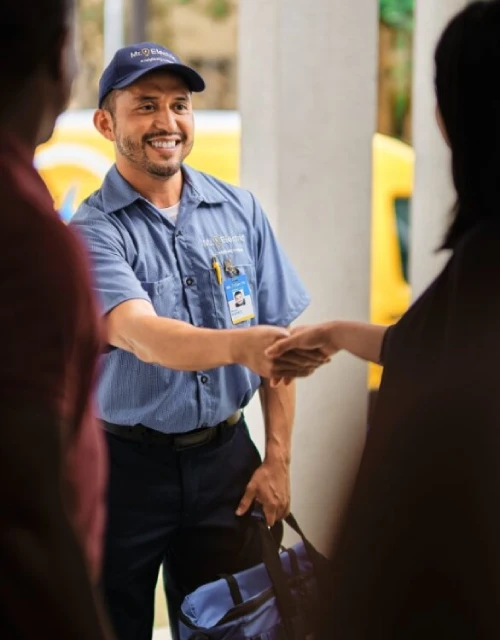 Mr. Electric technician shaking hands with a customer.