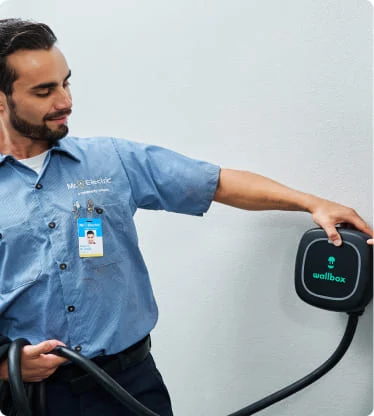 Electrician holding a wallbox.