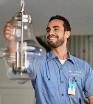 Electrician adjusting light fixture.