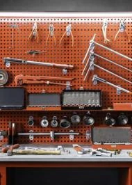 Garage lighting on a workbench filled with tools.