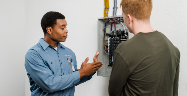 Mr. Electric electrician shows a customer their electrical panel.