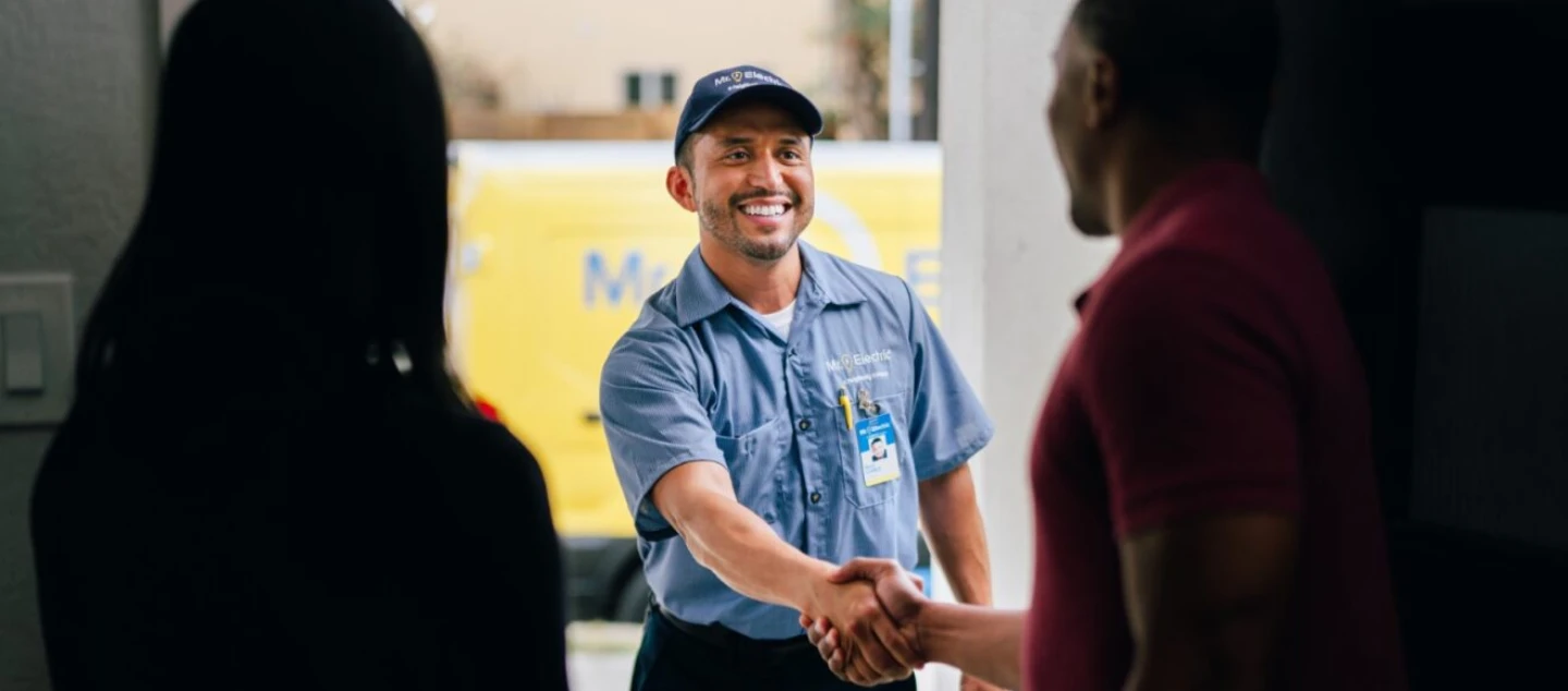 Mr. electric electrician shaking hands with a customer.