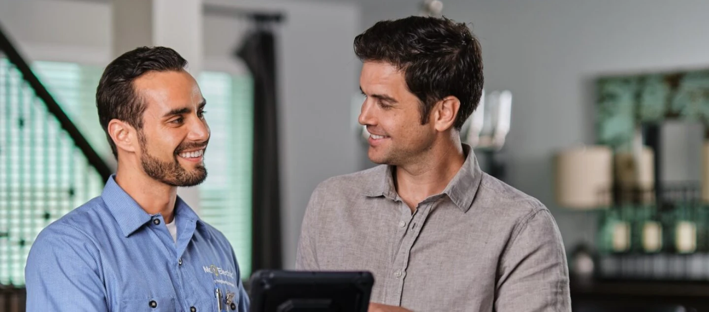 Smiling male customer with tablet.