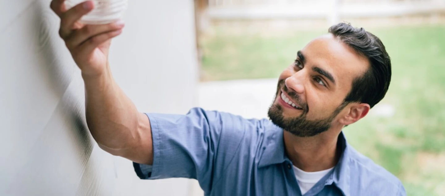 Mr. Electric electrician holding a light.