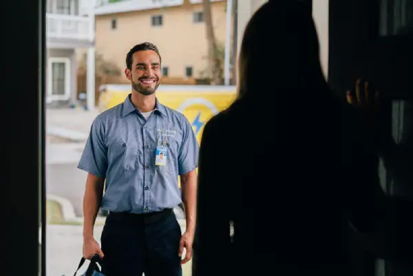 Mr. Electric electrician greeting a customer.