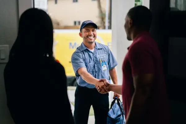 Mr. Electric electrician greeting a family at their door