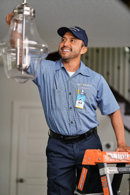 An electrician from Mr. Electric installing lights in a home in Gastonia, NC.