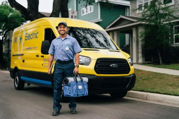 Mr. Electric electrician standing in front of a customer's home.