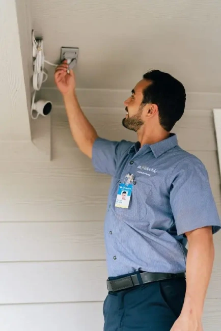 Mr. Electric electrician installing motion sensors.