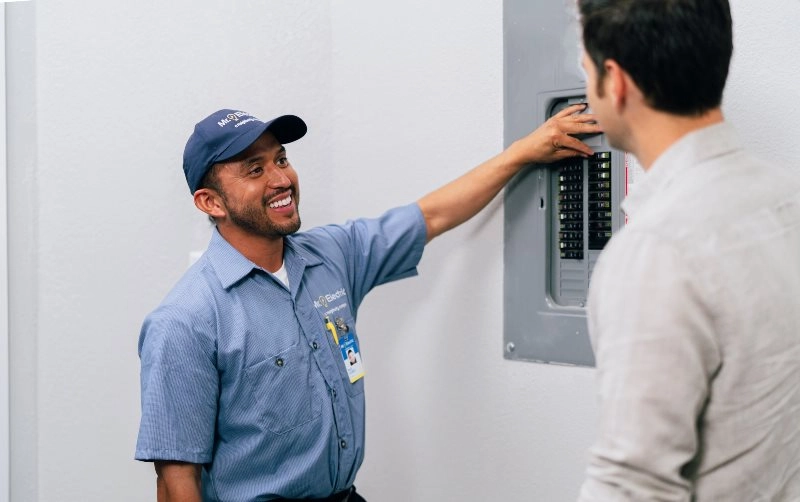 Mr. Electric of Lancaster County electrician explaining an electrical panel upgrade to a customer 