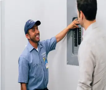 Mr. Electric electrician working on a circuit breaker 