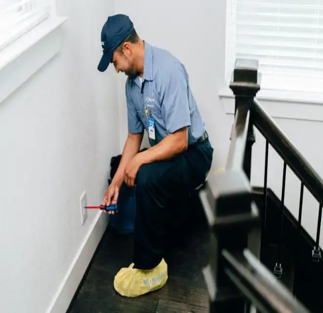 Mr. Electric electrician installing a power outlet in Houston Midtown, TX