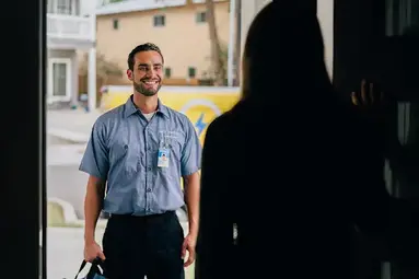 A woman in shadow talking to a technician.