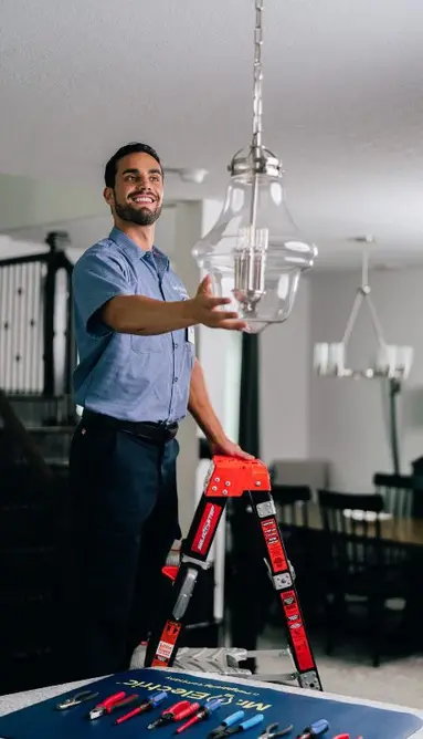 Mr. Electric electrician installing lighting.