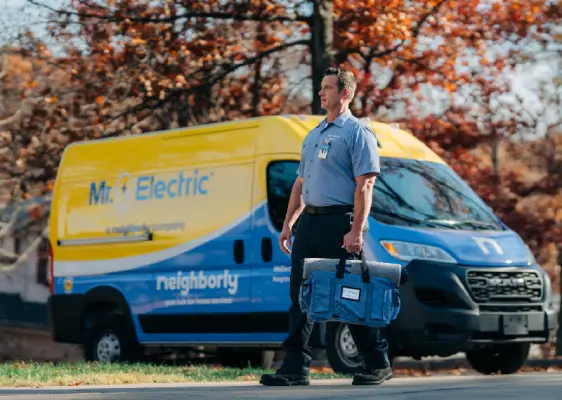 Mr. Electric electrician driving to customer's home to perform electrical wiring updates