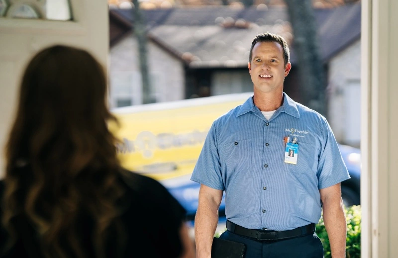 A Mr. Electric electrician greeting a customer at their house in Baton Rouge, LA.