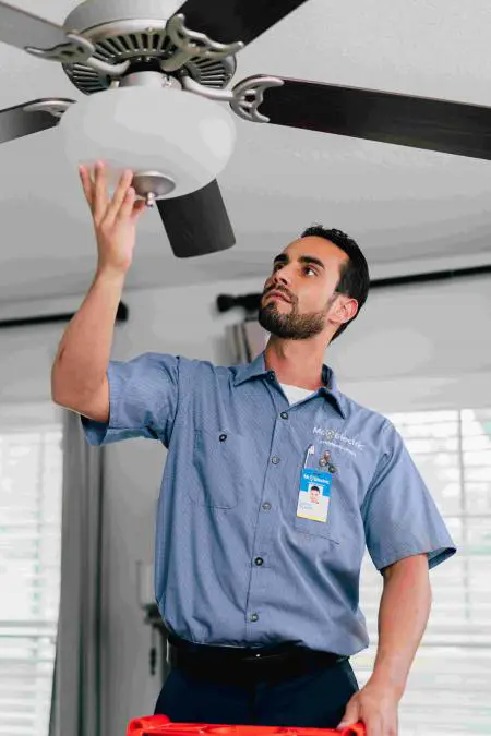 Mr. Electric electrician installing an indoor light.