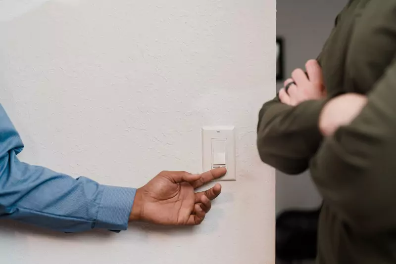 Mr. Electric electrician testing a light switch.