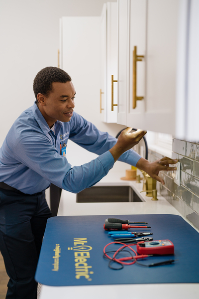 Mr. Electric electricians installing light switches.