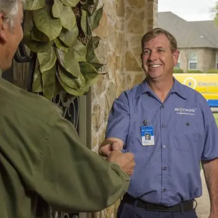 Mr electric shakes hands with customer.