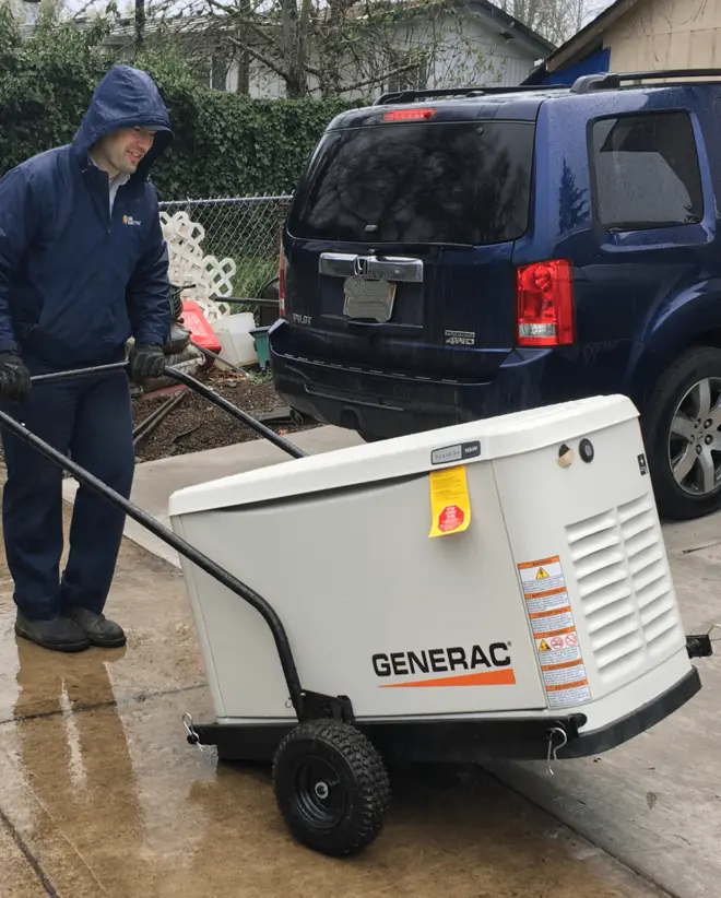 Mr. Electric associate pushing black trolley with Generac generator.