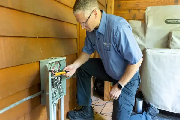 Testing circuit breaker with multimeter.