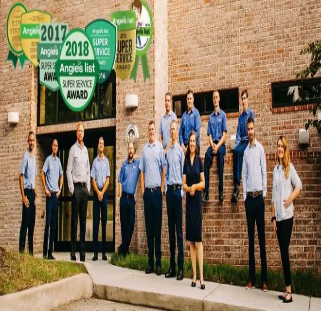 Mr. Electric of Jasper County Employees Standing Outside of Their Business with Logos of Awards They Received Over the Image.