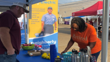 Mr. Electric of Tipton County team engaging with visitors at their booth.