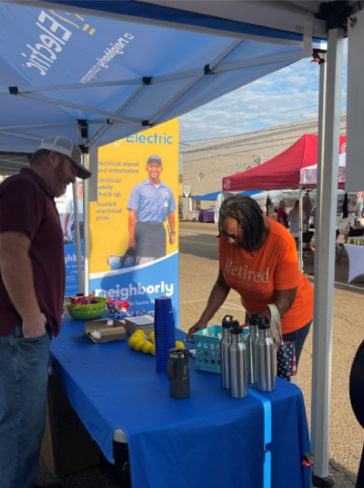 Mr. Electric of Tipton County team engaging with visitors at their booth.
