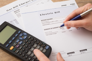 Person going over their electric bill on paper