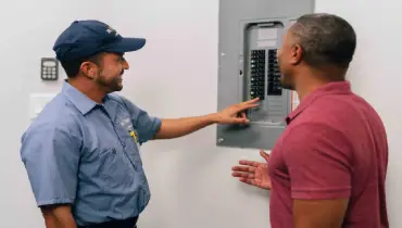 Mr.Electric professional showing a home electrical panel.