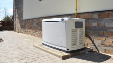 Backup whole home natural gas generator on side of a residential home.