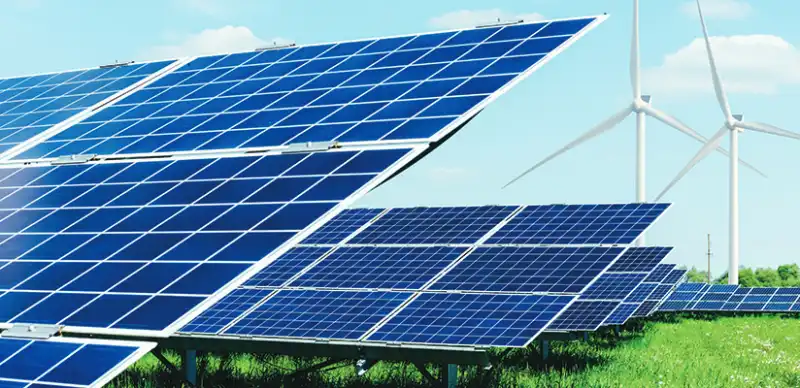 Solar panels and wind turbines in a field.